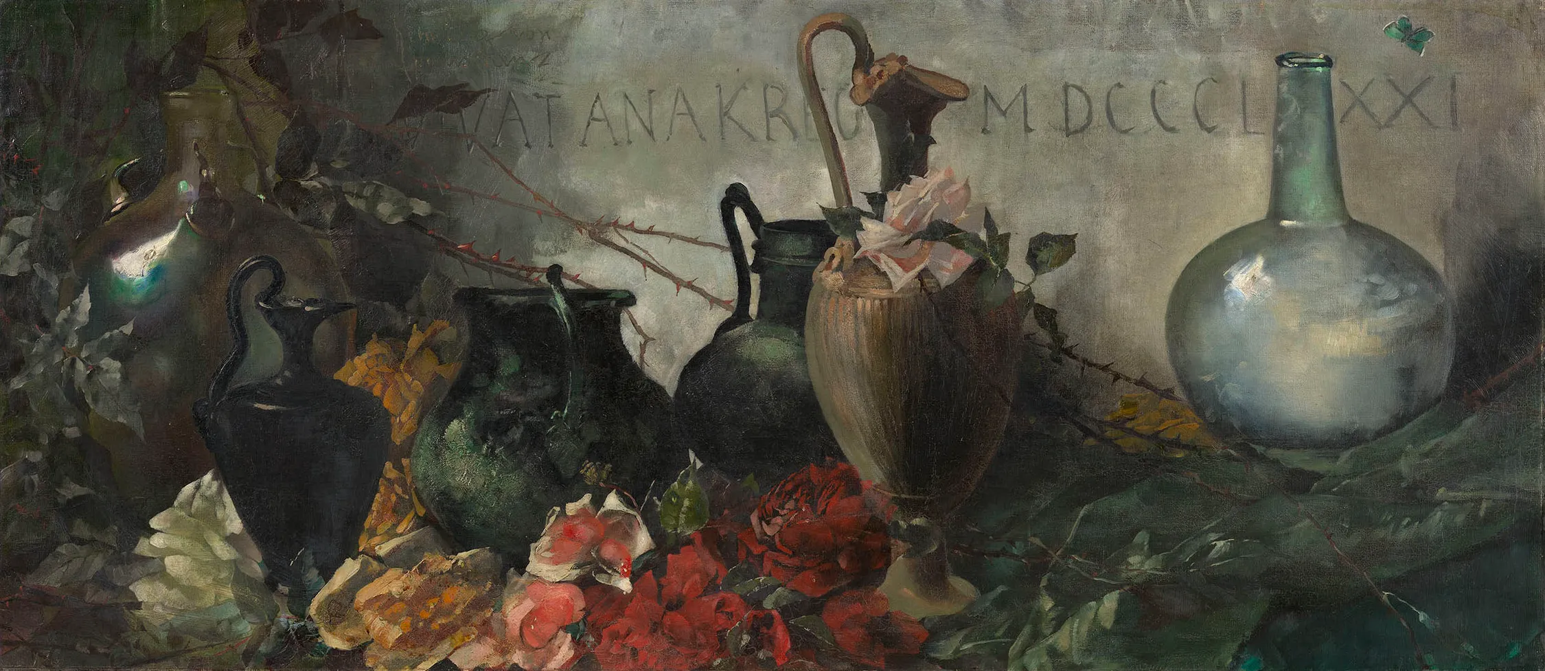 A horizontal still life of ornate vases and abundant cut flowers.